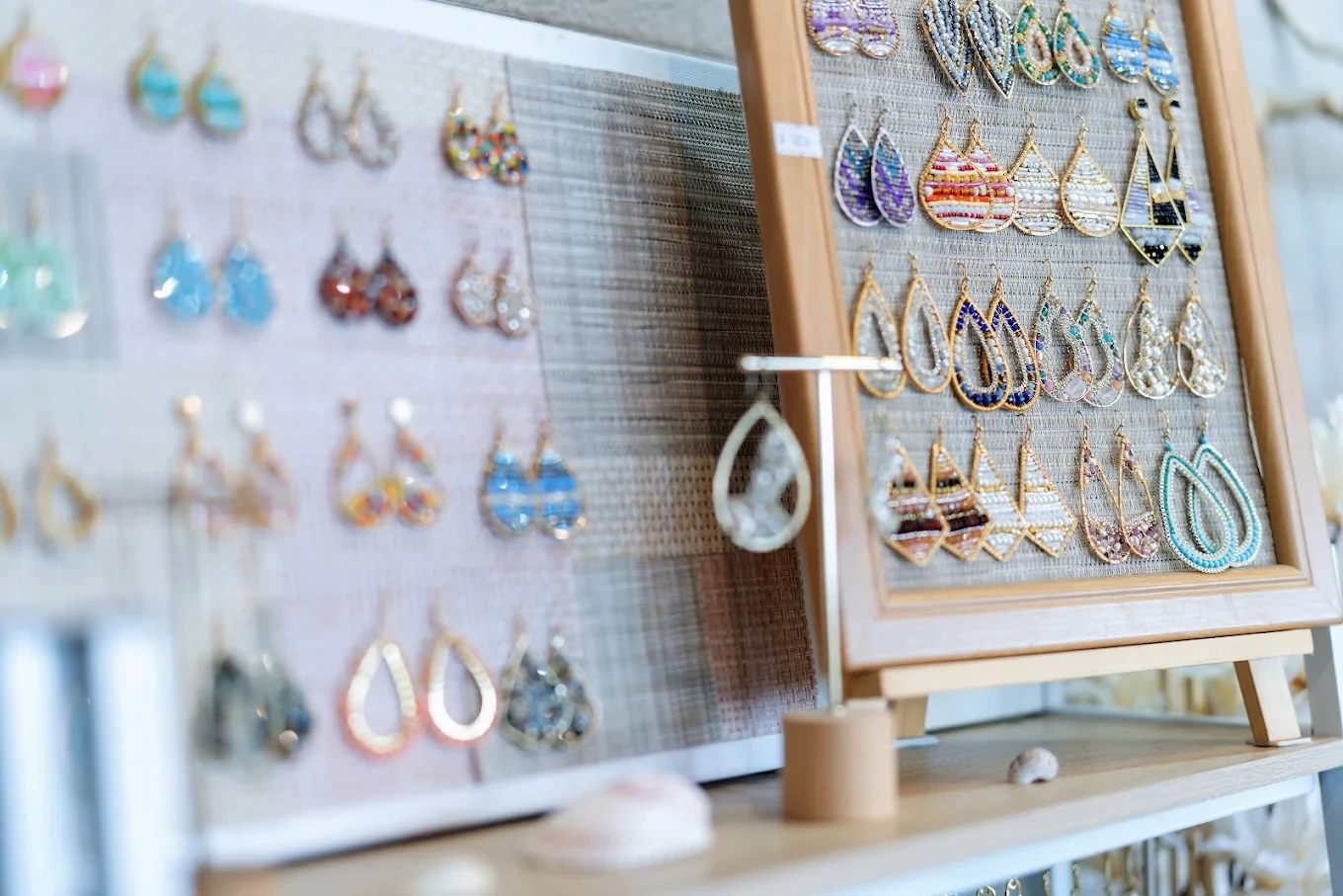 Rows of colorful earrings on Nakamol display stands