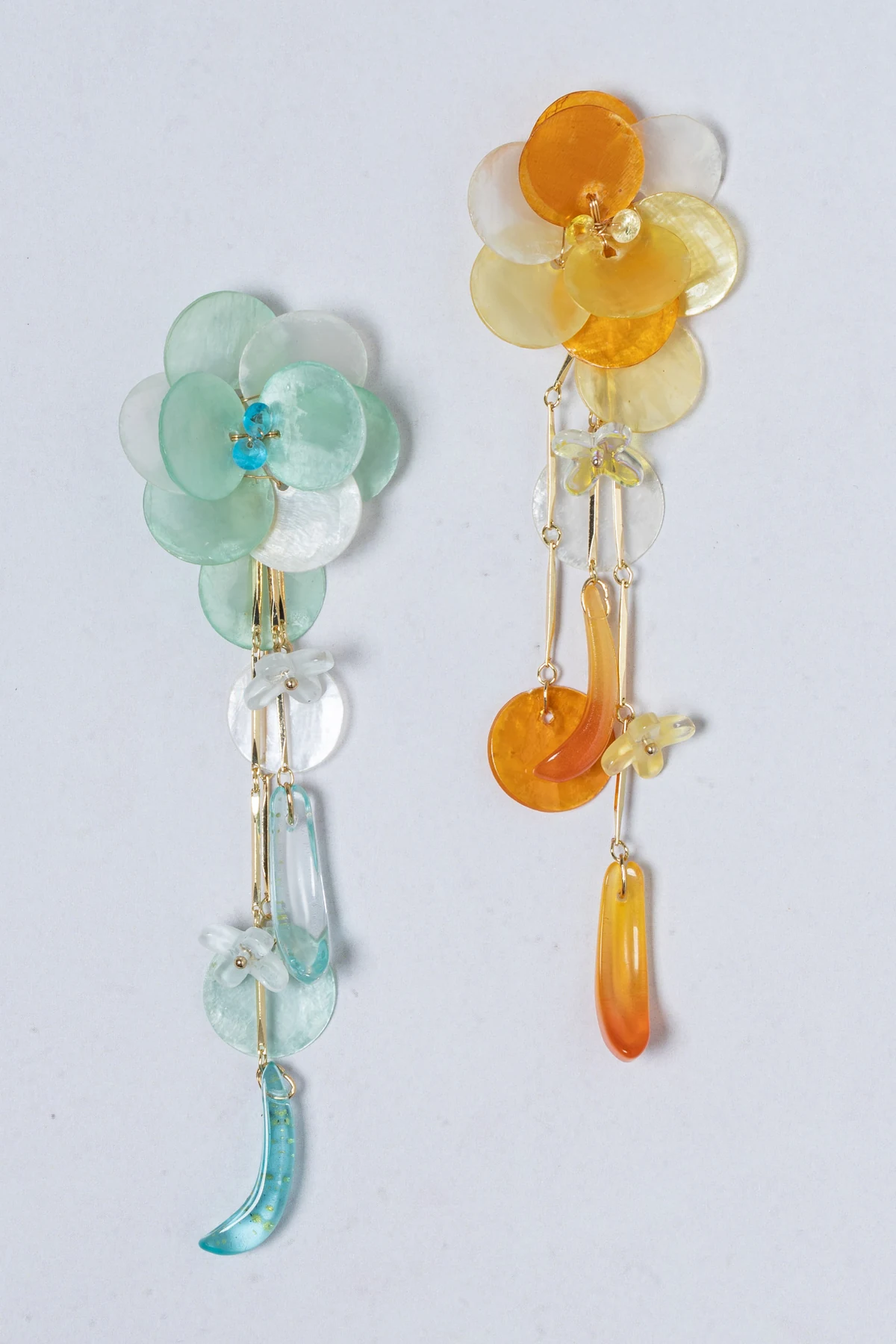 Translucent floral earrings with blue and amber accents