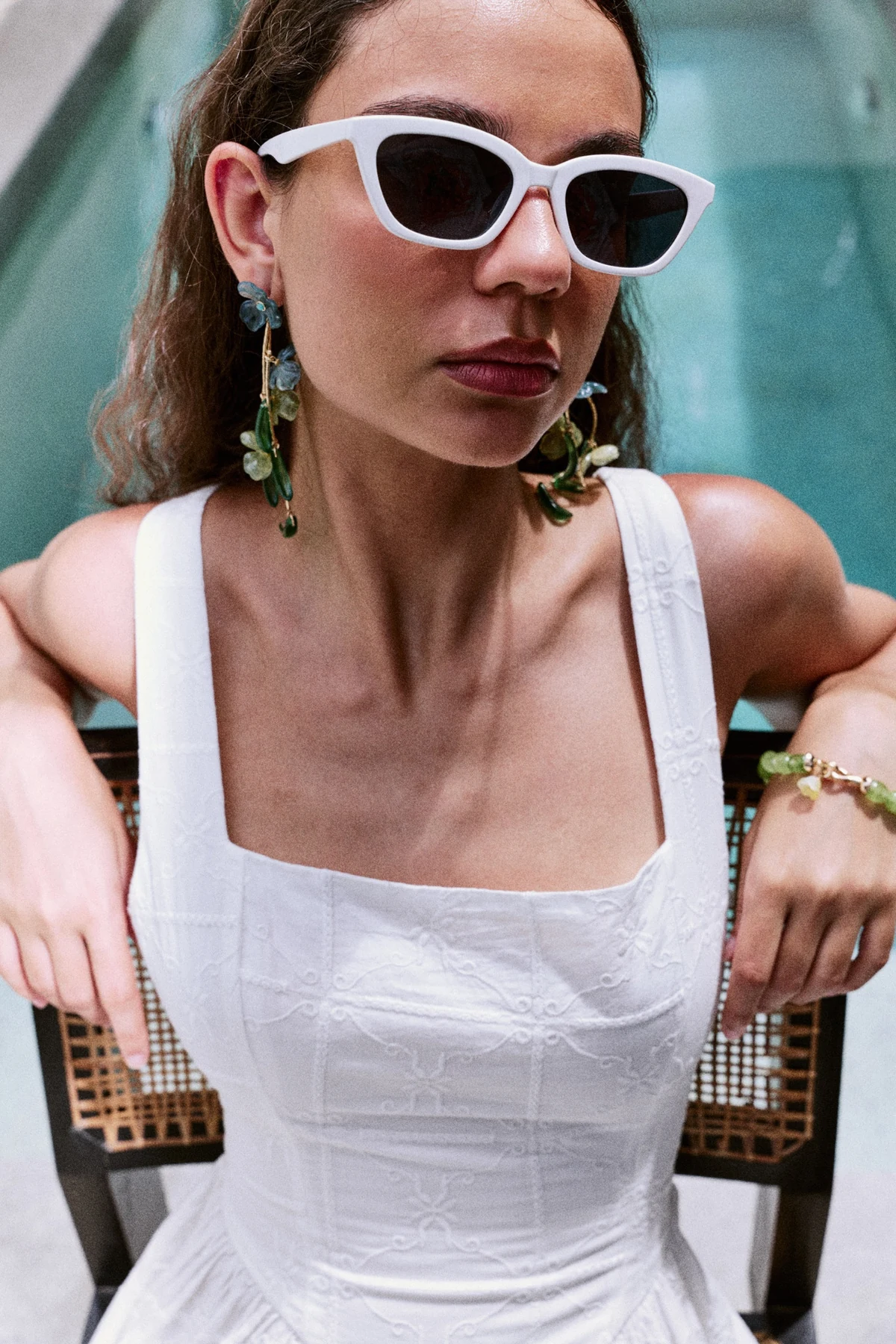 Nakamol earrings and bracelets styled with sunglasses and a white top